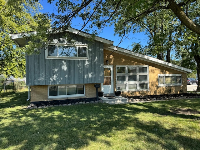 rear view of house with a yard