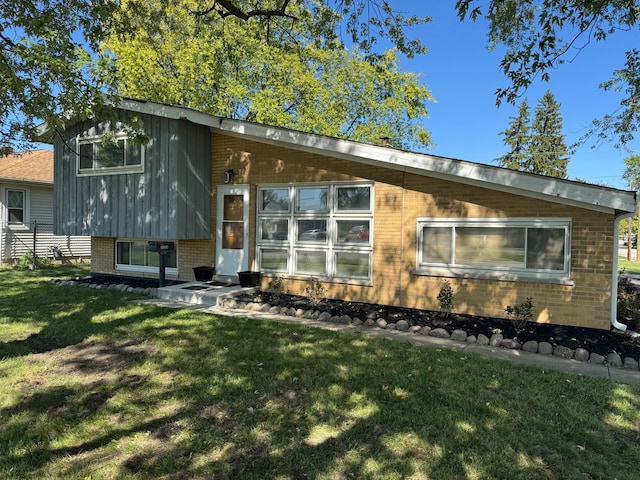 rear view of property featuring a yard