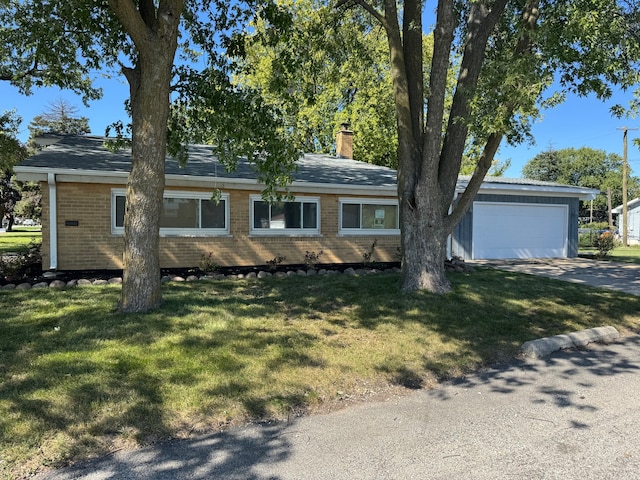 single story home with a garage and a front lawn