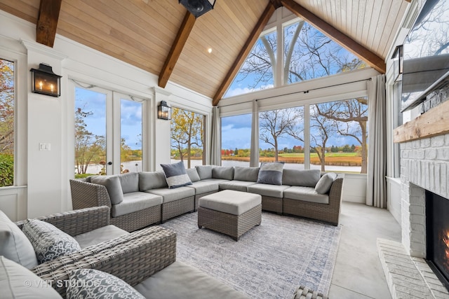 sunroom / solarium with vaulted ceiling with beams, french doors, and a brick fireplace