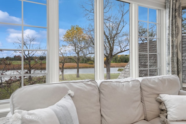 sunroom / solarium with a water view