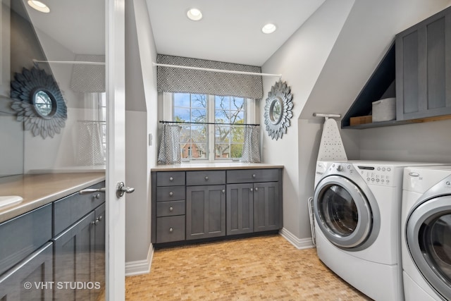 laundry room with washer and clothes dryer and cabinets