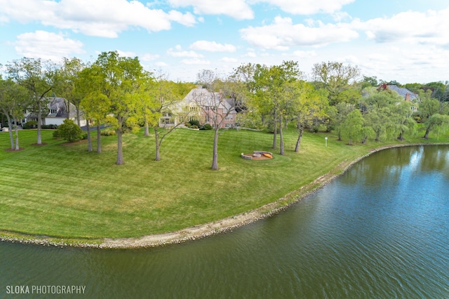 view of home's community featuring a yard and a water view