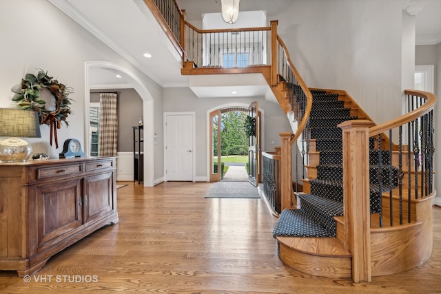 entrance foyer with light hardwood / wood-style flooring and ornamental molding