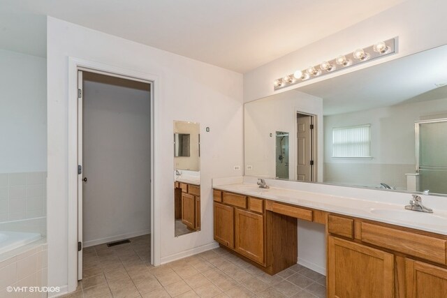 bathroom with independent shower and bath, vanity, and tile patterned floors