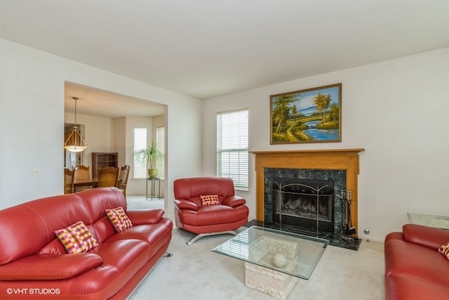 carpeted living room with a premium fireplace