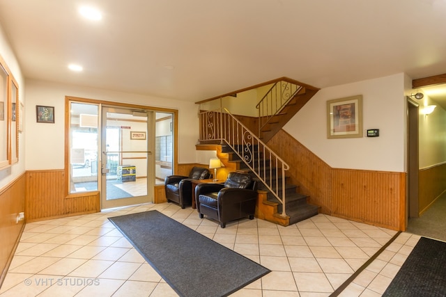 tiled foyer entrance featuring wooden walls