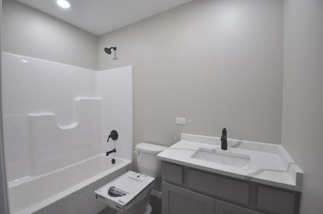 full bathroom featuring toilet, vanity, and washtub / shower combination