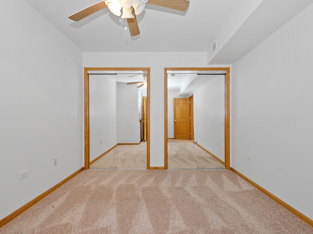 unfurnished bedroom with light carpet and ceiling fan