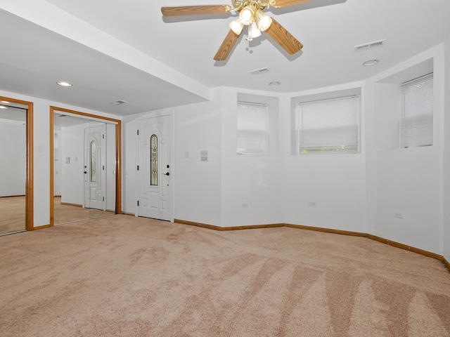 carpeted empty room featuring ceiling fan