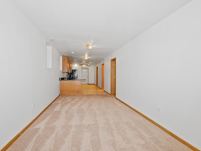 unfurnished living room featuring light carpet