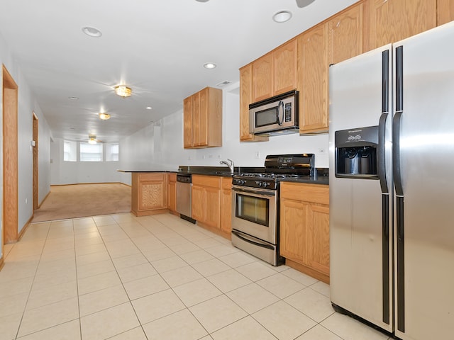 kitchen featuring appliances with stainless steel finishes, light tile patterned floors, and sink