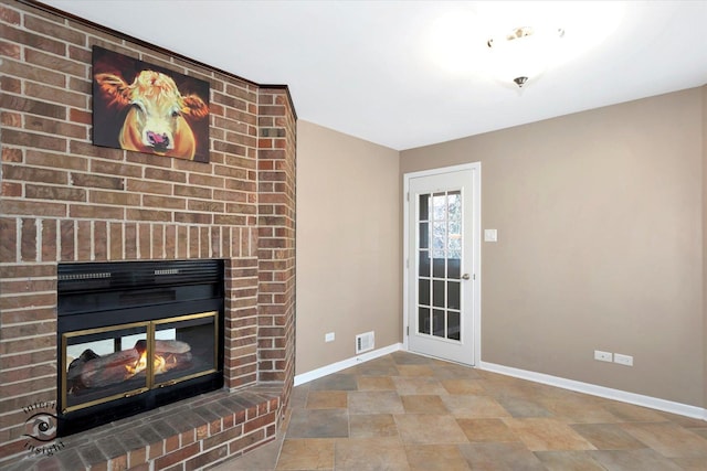 living area featuring a brick fireplace, visible vents, stone finish flooring, and baseboards