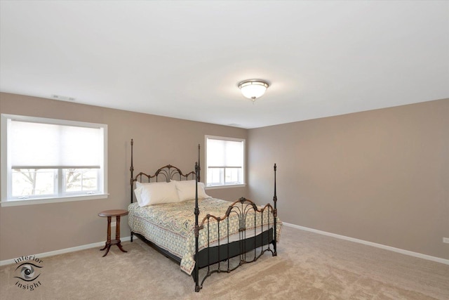 bedroom featuring baseboards, visible vents, and light colored carpet