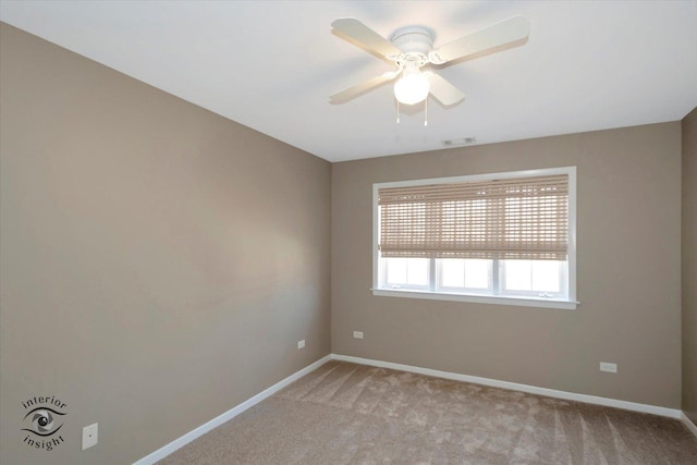 empty room with light carpet, ceiling fan, visible vents, and baseboards