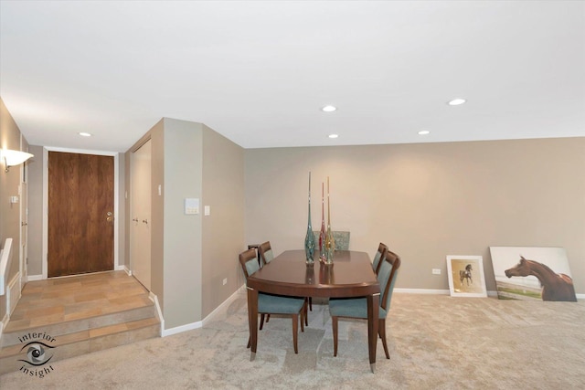 dining room with recessed lighting, light colored carpet, and baseboards