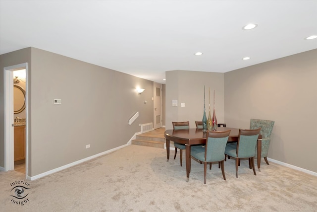 dining space featuring light colored carpet, visible vents, baseboards, and recessed lighting