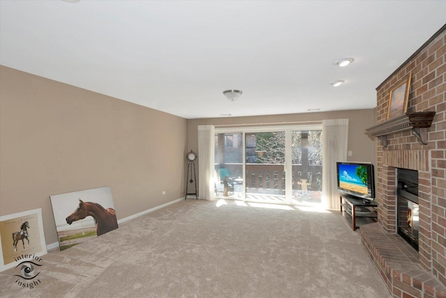 unfurnished living room featuring carpet floors, a fireplace, and baseboards