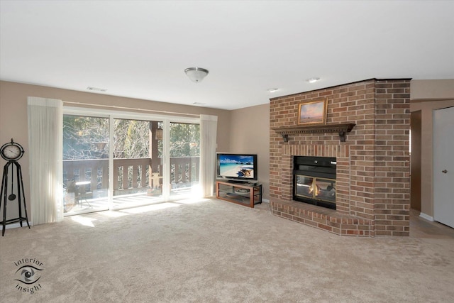 unfurnished living room featuring a fireplace, visible vents, and carpet flooring