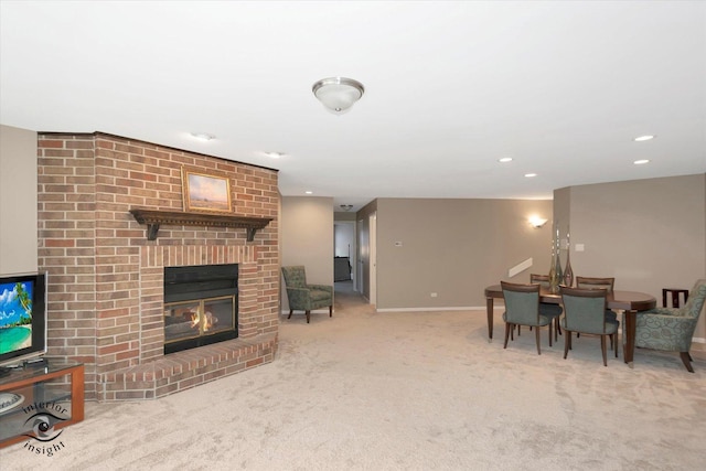 carpeted living area with recessed lighting, a fireplace, and baseboards