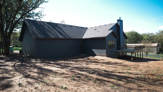 rear view of house featuring a deck