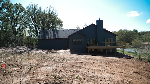 back of house featuring a deck with water view