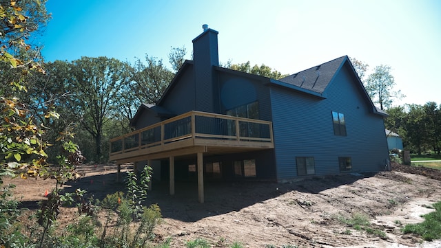 rear view of property featuring a deck