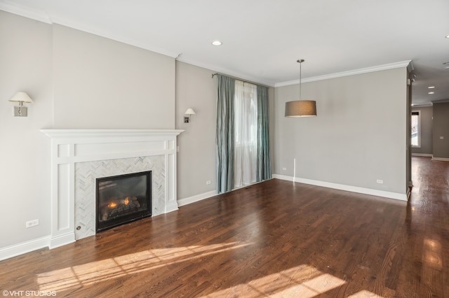 unfurnished living room featuring hardwood / wood-style flooring, a tiled fireplace, and ornamental molding