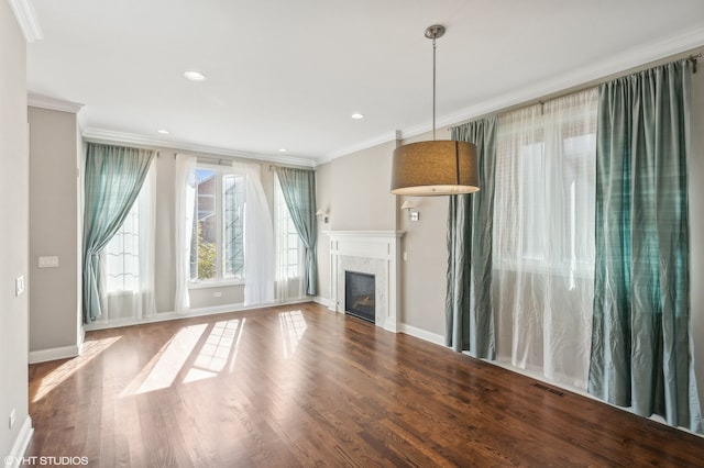 unfurnished living room with crown molding and hardwood / wood-style floors