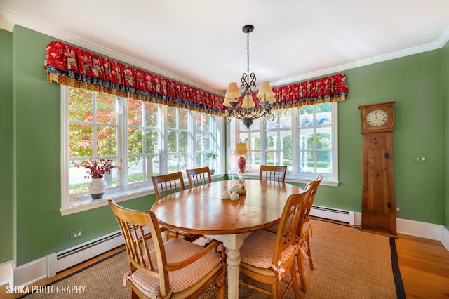 dining room featuring baseboard heating, wood-type flooring, a healthy amount of sunlight, and a notable chandelier