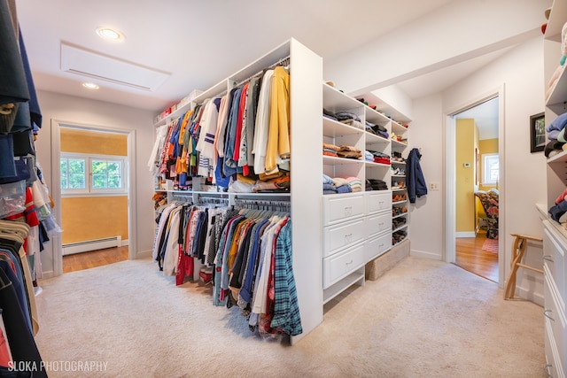 spacious closet featuring light colored carpet and baseboard heating