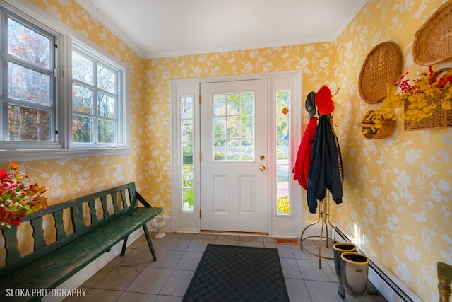 tiled foyer featuring baseboard heating and crown molding