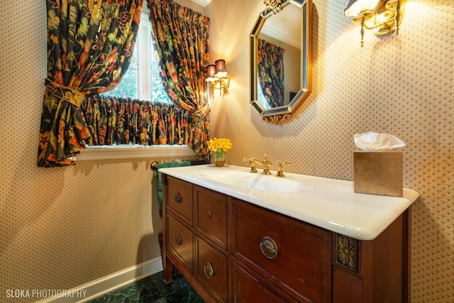 bathroom featuring vanity, marble finish floor, and baseboards