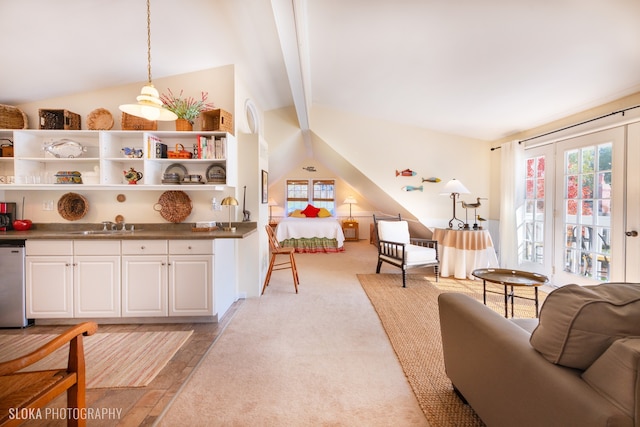 carpeted living room featuring lofted ceiling with beams