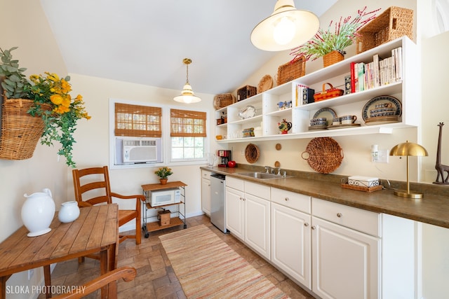 kitchen featuring dishwasher, sink, cooling unit, lofted ceiling, and white cabinets