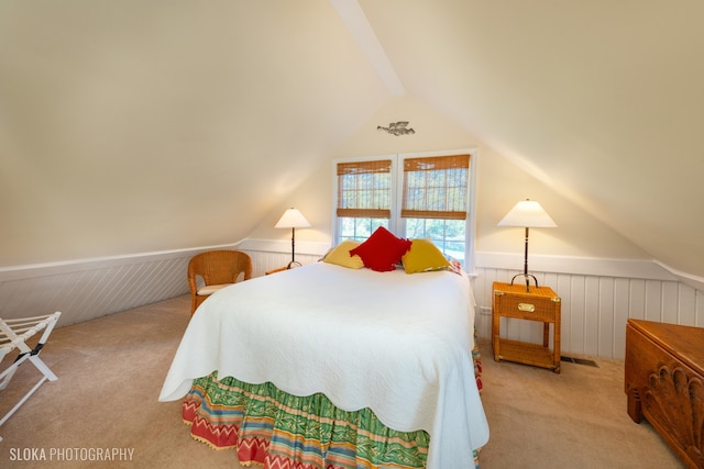 bedroom with light carpet, vaulted ceiling, and wooden walls