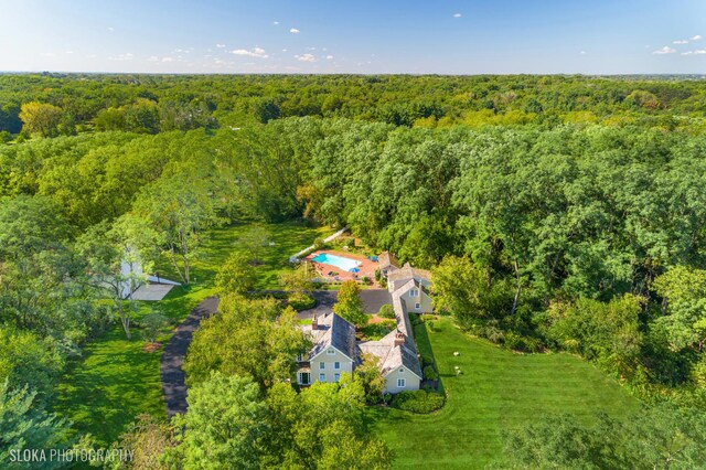 birds eye view of property with a forest view