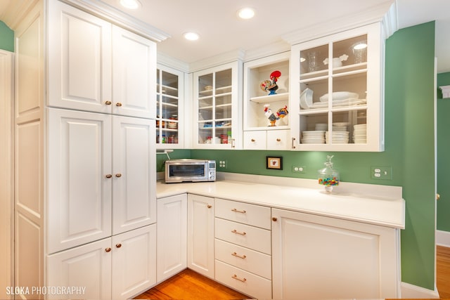 kitchen featuring white cabinets and light hardwood / wood-style floors