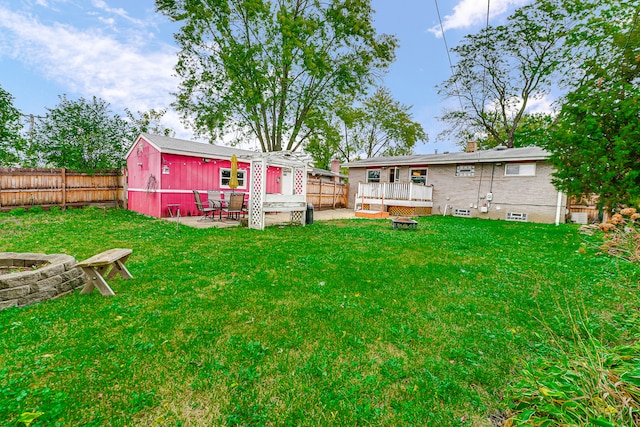 view of yard with a wooden deck and a patio