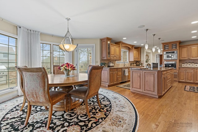 dining room with sink and light hardwood / wood-style flooring