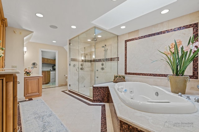 bathroom with tile patterned flooring, vanity, and shower with separate bathtub