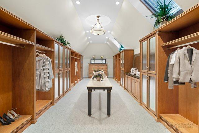 interior space featuring vaulted ceiling and light colored carpet