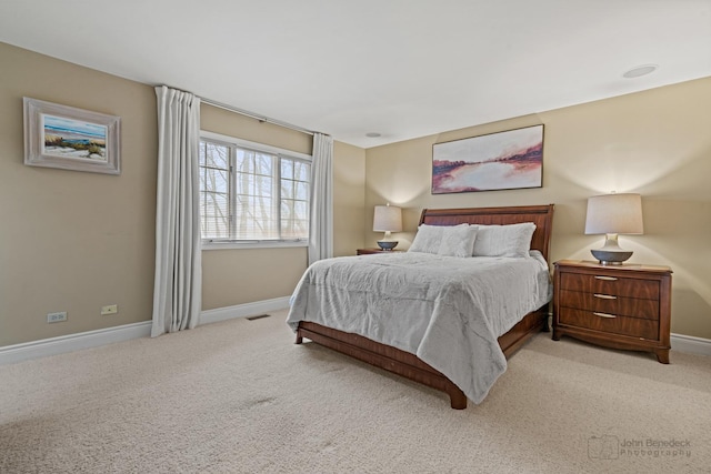 bedroom featuring light carpet