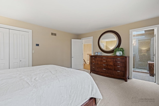 bedroom featuring light carpet, ensuite bath, and a closet