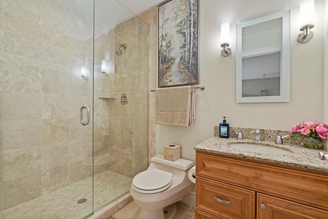 bathroom featuring an enclosed shower, vanity, and toilet