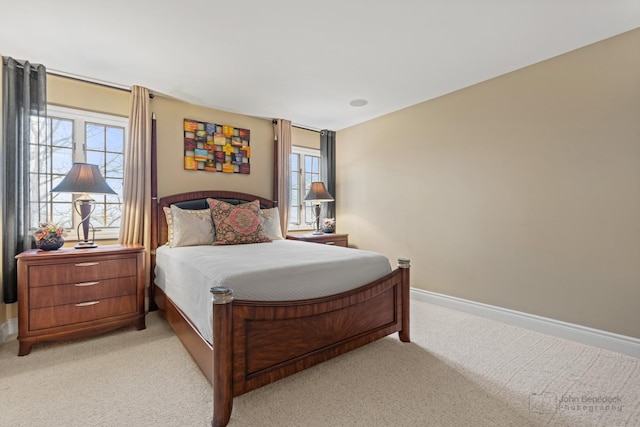 bedroom featuring multiple windows and light carpet