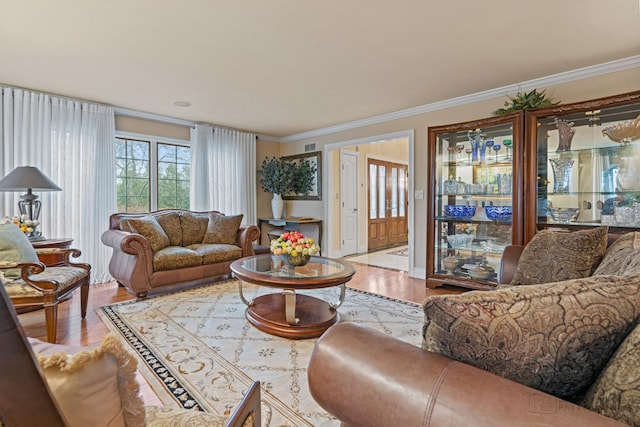 living room featuring crown molding and light wood-type flooring