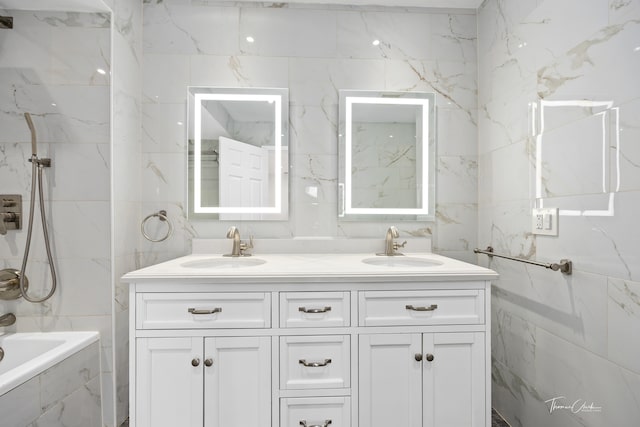 bathroom with tile walls, vanity, and tiled shower / bath combo