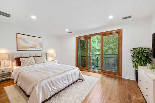 bedroom with light hardwood / wood-style floors and access to exterior