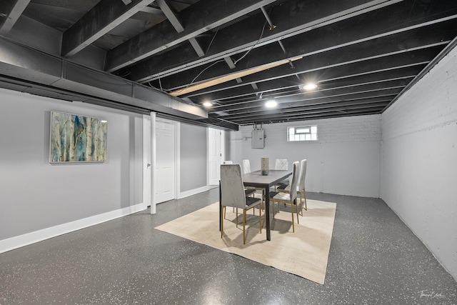 dining area with brick wall and electric panel